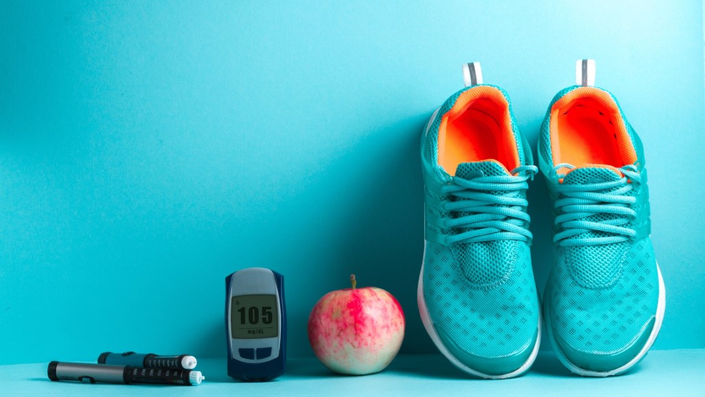 workout shoes, an apple, a stopwatch and insulin injections