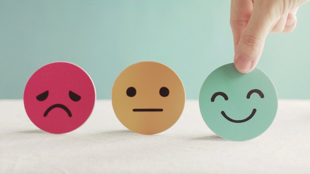 three icons: one sad, one neutral and one happy