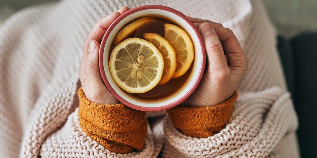 first person POV with tea in lap with lemon