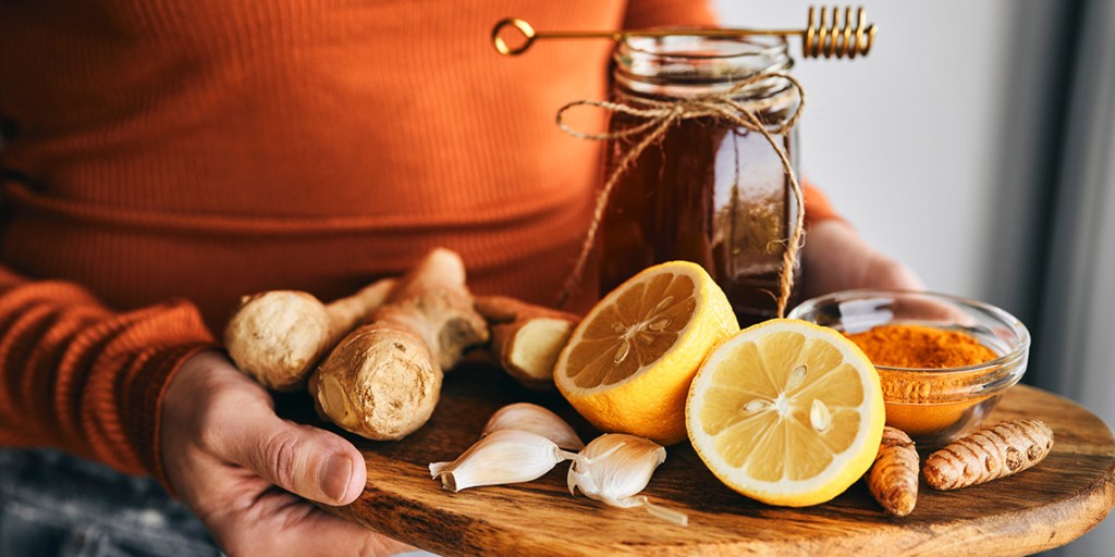 lemon, honey, garlic and turmeric on a board