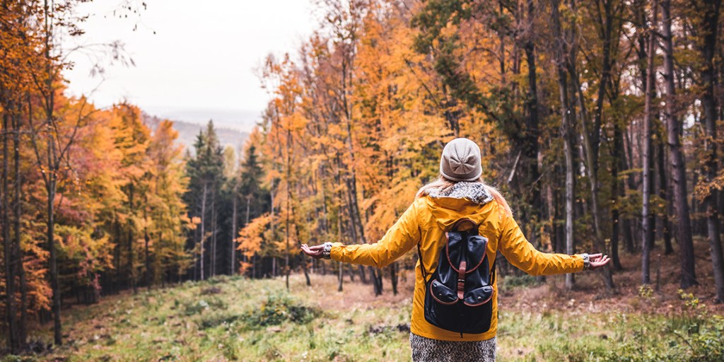 woman outside looking towards the trees