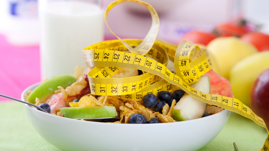 measuring tape on top of a fruit salad in a bowl