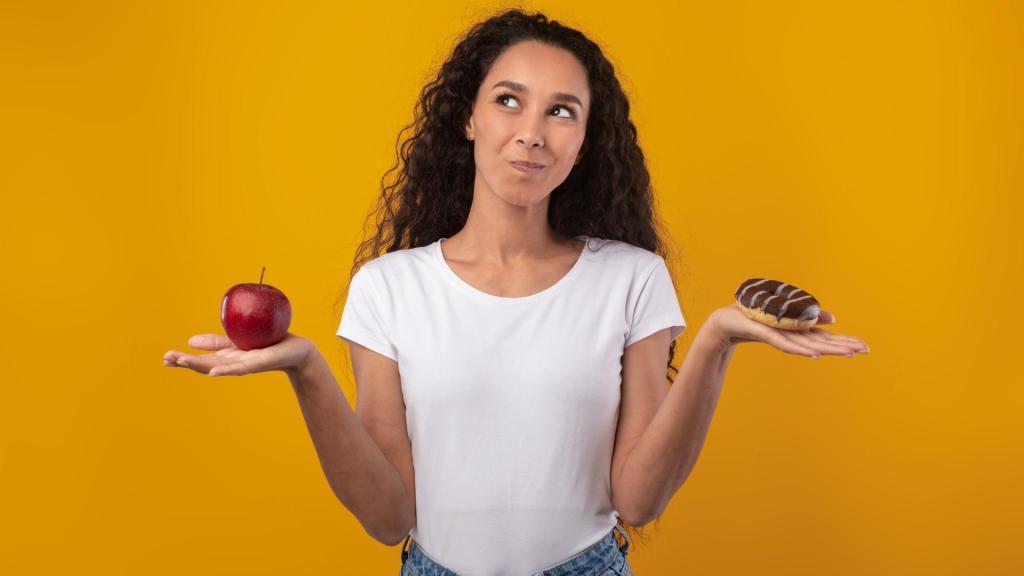 Woman debating between an apple and a dessert in each hand
