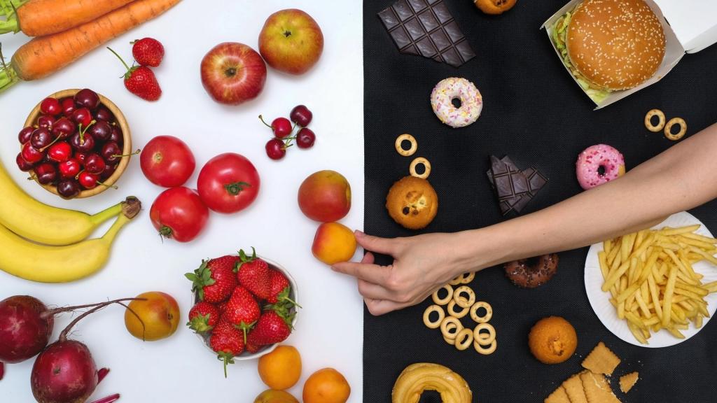 Variety of foods laid on a surface split in half, with healthy food on the left and unhealthy food on the right.