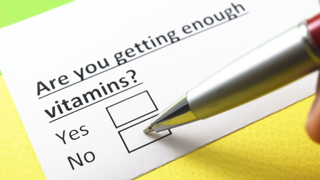 A pen is marking the "No" box in response to the question "Are you getting enough vitamins?" on a form.