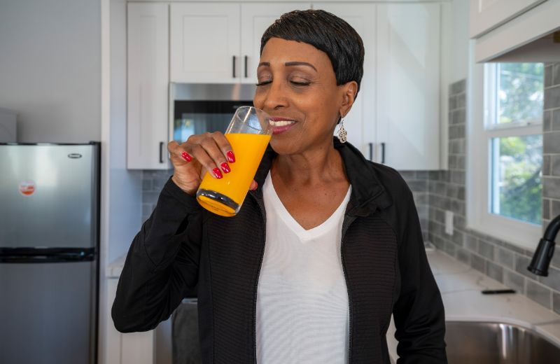 Woman sipping an orange drink