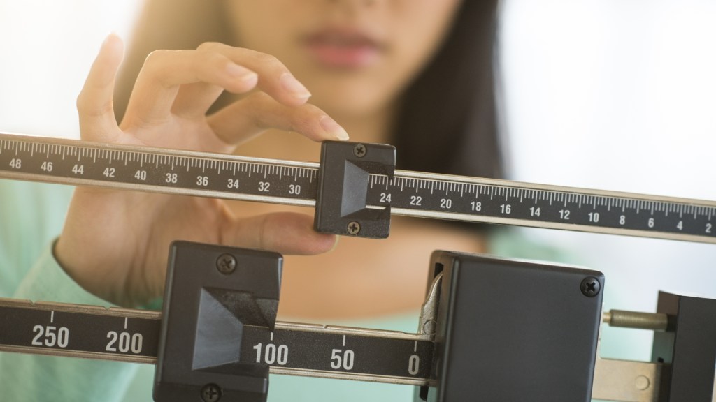 person weighing themselves on scale