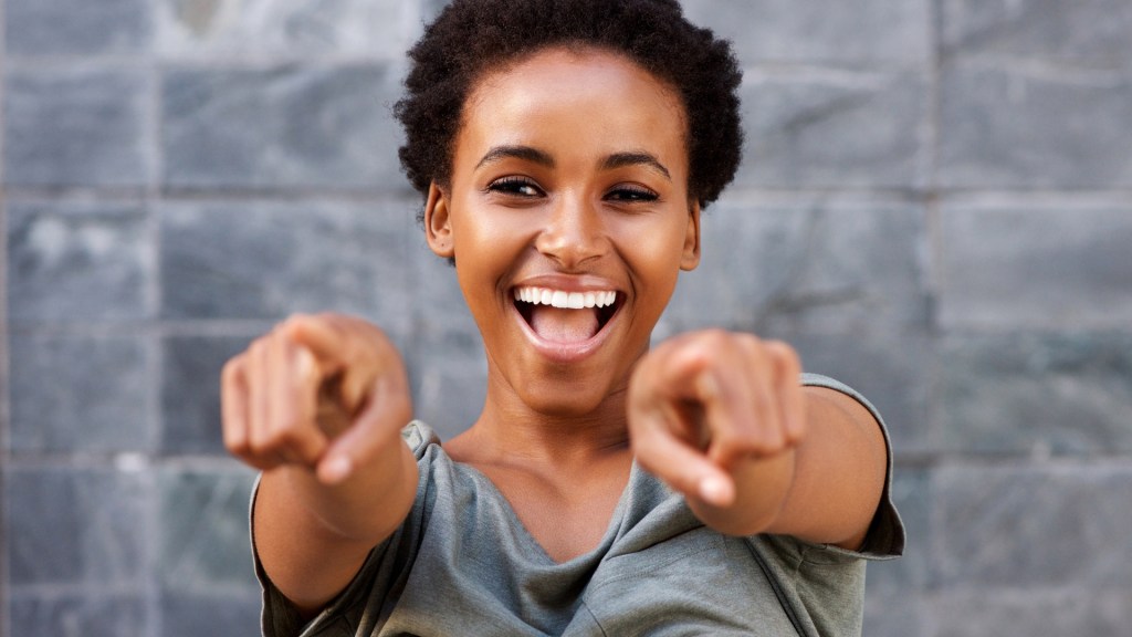 woman pointing with smiling face
