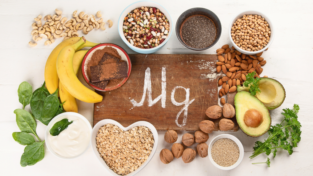Mg written in chalk on board with sources of magnesium including avocadoes, bananas, and more