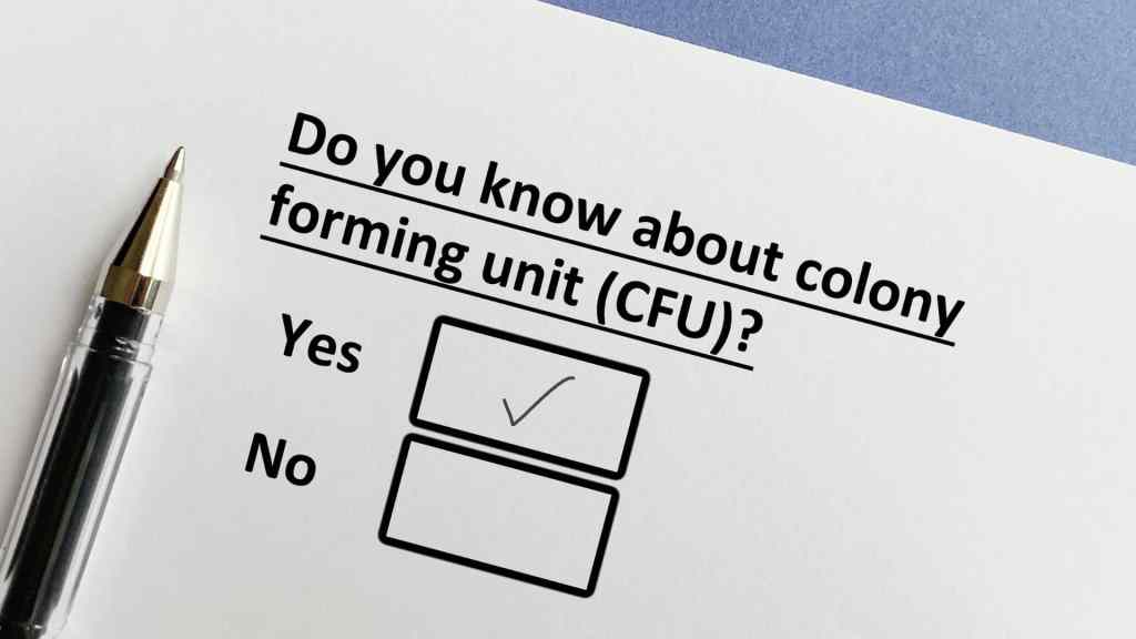 A printed survey question asks about knowledge of colony forming units (CFU) with "Yes" checked and a pen beside the paper.