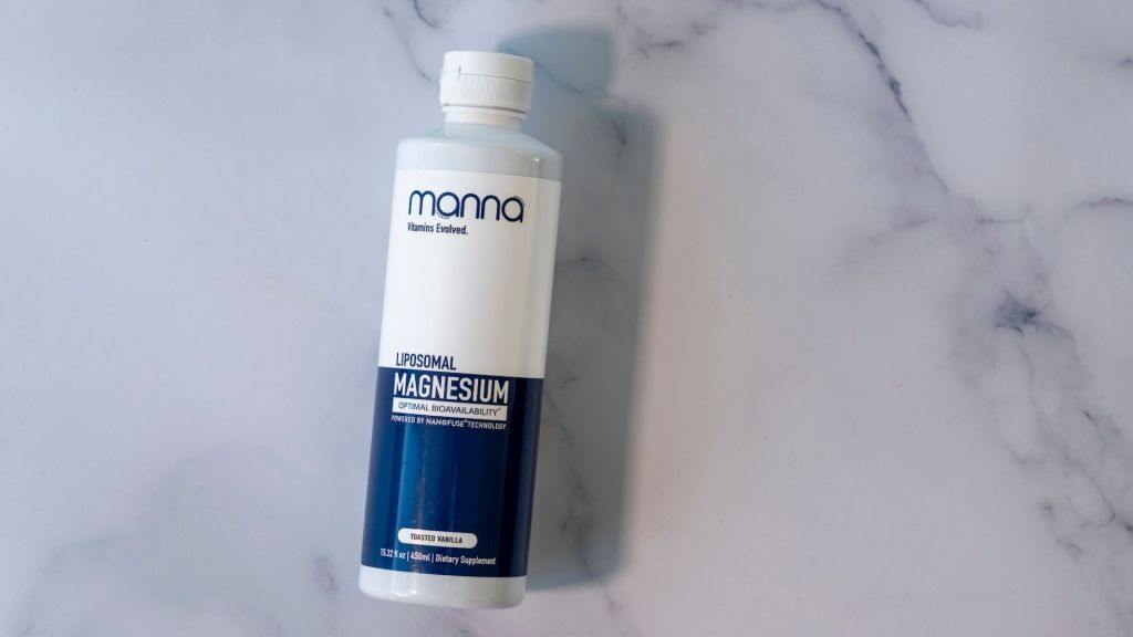 A bottle of Manna Liposomal Magnesium on a marble surface.