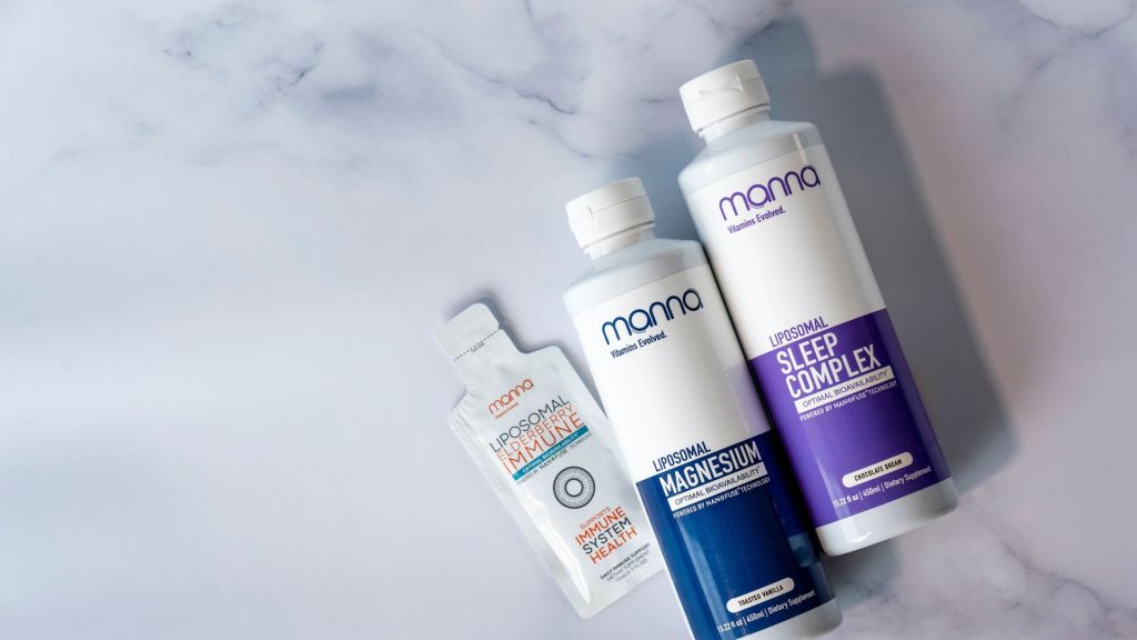 Bottles of dietary supplements labeled "Immune," "Magnesium," and "Sleep Complex" on a marble surface.