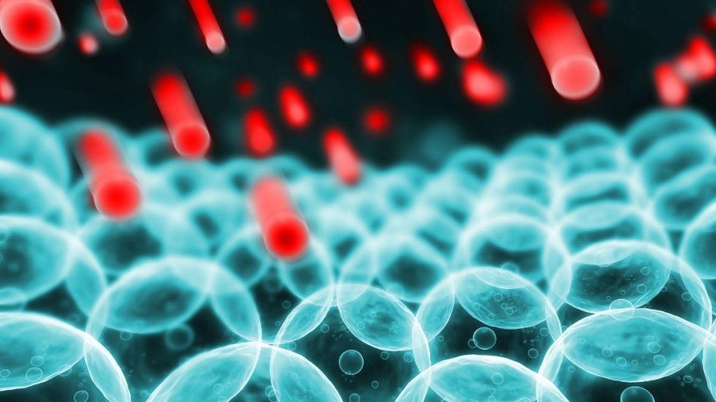 Rendered image of red particles bombarding blue cells.