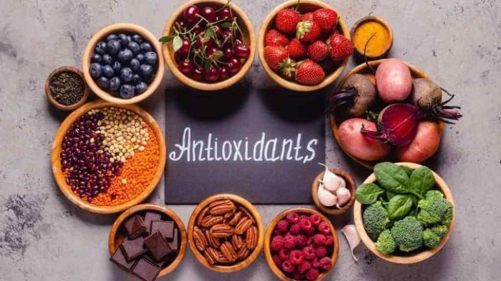 A variety of antioxidant-rich foods displayed around a sign reading "antioxidants.