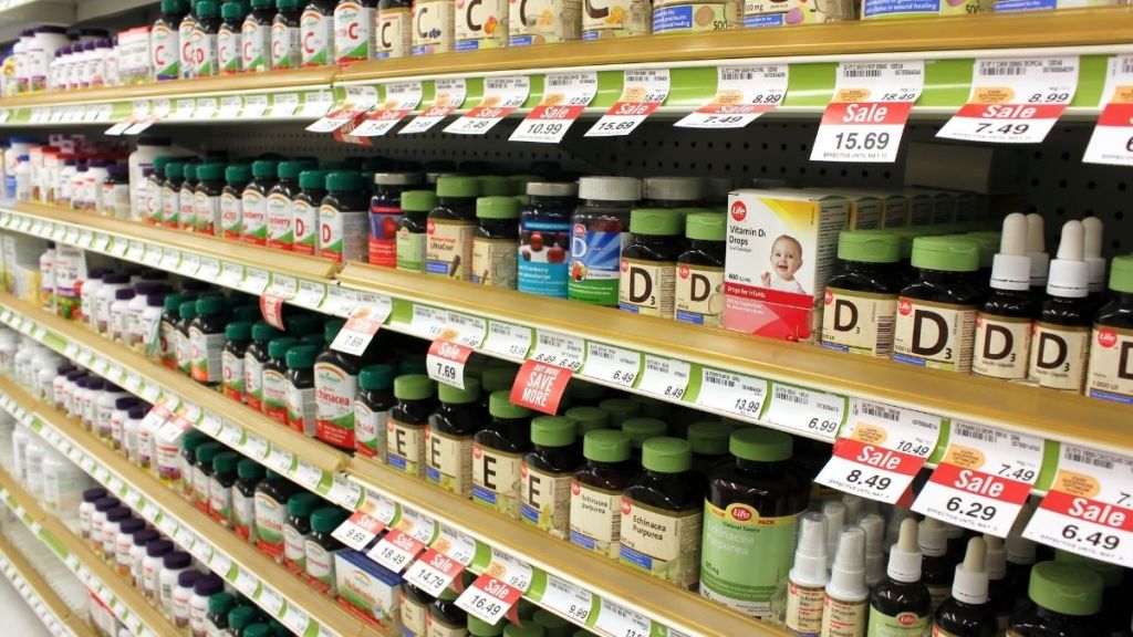 Supplement aisle in a store with stocked shelves.